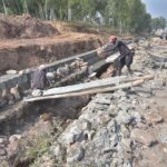 Workers busy in construction work near Tramri Chowk in the Federal Capital