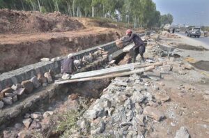 Workers busy in construction work near Tramri Chowk in the Federal Capital