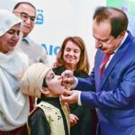 Caretaker Federal Health Minister Dr. Nadeem Jan administrating polio drops during polio campaign.