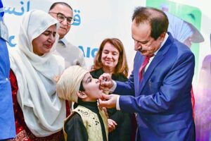 Caretaker Federal Health Minister Dr. Nadeem Jan administrating polio drops during polio campaign.