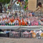 A vendor displaying decorative items to attract customers at roadside setup