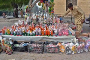 A vendor displaying decorative items to attract customers at roadside setup