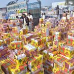 Vendors busy bidding of persimmon fruit boxes on whole sale rate at fruit and vegetable Market in the Federal Capital.