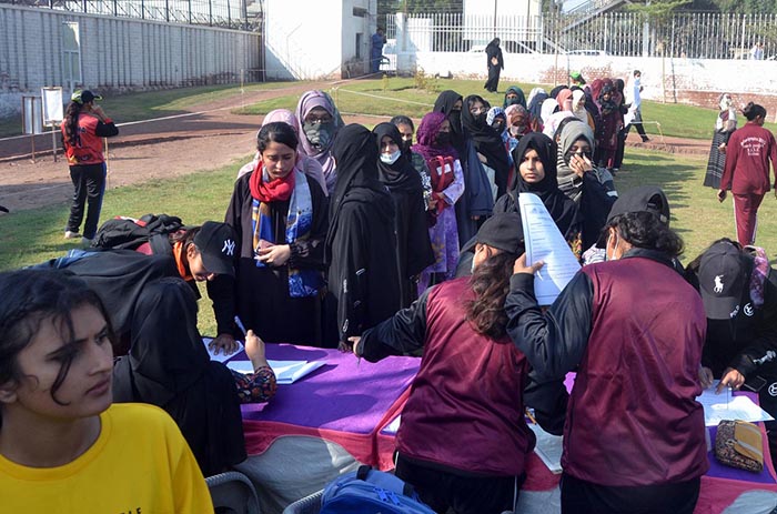 A large number of girls students standing in a queue to register for open trials for the Elite Women's Cricket League under the Lodhran Pilot Project (LPP) at Groundup Academy.