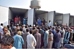 Vendors busy bidding of persimmon fruit boxes on whole sale rate at fruit and vegetable Market in the Federal Capital.