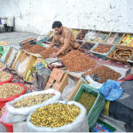 A vendor displaying and selling dry fruit on the roadside to attract customers