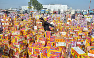 A labourer carrying crates of fruit at Fruit and Vegetable Market.