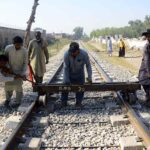 Railway staffers pushing railway track push cart on a track for repairing the track near Haji capm.