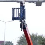 A worker busy in the repairing CCTV cameras during maintenance work in Federal Capital.
