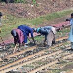 Labourers busy in repairing the rail track near railway station.