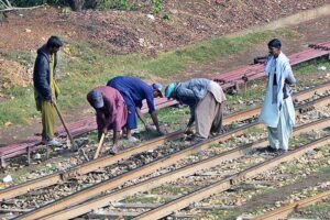 Labourers busy in repairing the rail track near railway station.
