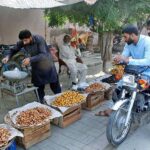 Vendor displaying and selling different verities of dates to attract customers at roadside