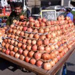 Vendor displaying pomegranates on his handcart to attract the customer at his roadside setup