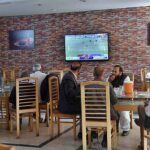 People watching final of ICC Cricket World Cup 2023 on TV in a local cafe in Provincial Capital