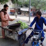 A vendor selling corncob to earn his livelihood on roadside in the city