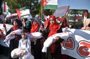 Students showing solidarity with the children of Palestine during march at Charing Cross Chowk, Main Peshawar Road.