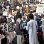 People busy in purchasing second hand warm clothes from vendors in a local market of Provincial Capital