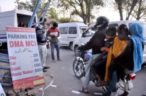 A staffer of Municipal Corporation Islamabad (MCI) receipts weekly Bazaar Parking Fees from the commuters newly launched by District Municipal Administration in the Federal Capital