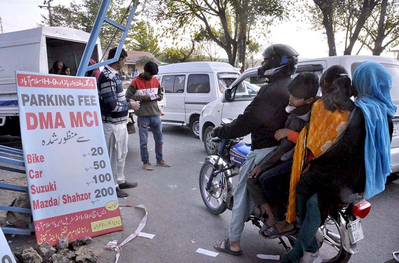 A staffer of Municipal Corporation Islamabad (MCI) receipts weekly Bazaar Parking Fees from the commuters newly launched by District Municipal Administration in the Federal Capital