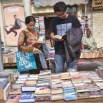 People busy in selecting and purchasing old books from roadside setup in Provincial Capital.