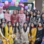 Assistant Commissioner Cantt Qandeel Fatima and Principal Maimoona Yasmeen in a group photo with students on the occasion of fun fair held at Associate College Railway Road.