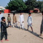 Children are playing Guli Danda in a local ground