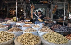 A shopkeeper arranging and displaying dry fruit to attract the customers at G-9 Markaz.