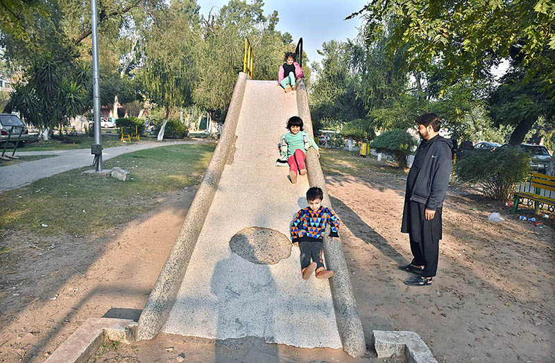 Children joyfully sliding down the slide at Sitara Market