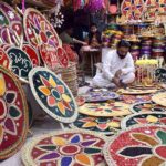 A vendor preparing the different kind of decorative stuff use for marriage ceremonies at his workplace