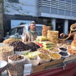 A vendor displays fresh figs (anjeer) on his handcart to attract customers