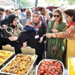 First Lady Begum Samina Alvi visiting stalls featuring traditional cuisines, arts and crafts of different countries at Pakistan Foreign Office Women's Association's Annual Charity Bazar