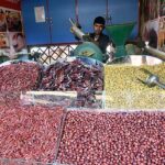 A vendor selling red chili at weekly bazar Peshawar Mor.