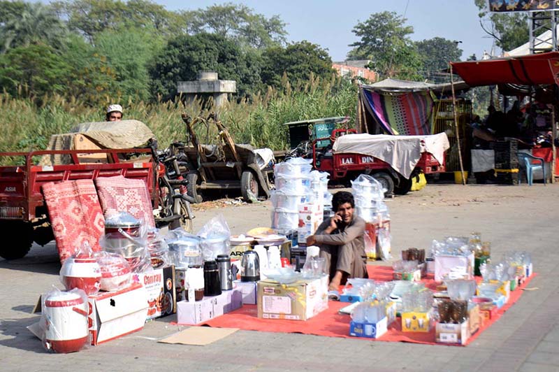 A vendor displays plastic containers to attract customers at his roadside setup