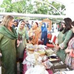 First Lady Begum Samina Alvi visiting stalls featuring traditional cuisines and arts and crafts of different countries at Pakistan Foreign Office Women's Association's Annual Charity Bazar