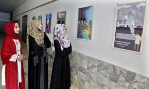 Visitor capturing the moments through cell phone during “Jashan-e-Maholiat” Art paintings for Environment Exhibition organized by Sindh Community Foundation (SCF) at Mehran Arts Council