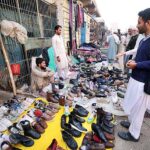 Vendor selling and displaying second hand shoes to attract the customers at Hashtnagri area