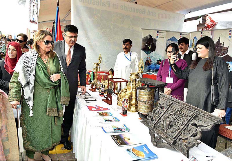 First Lady Begum Samina Alvi visiting stalls featuring traditional cuisines and arts and crafts of different countries at Pakistan Foreign Office Women's Association's Annual Charity Bazar