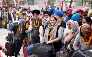 A large number of Sikh Yatrees stands in queue at Waghah Border for immigration procedure after arriving in Pakistan to participate in religious rituals on the occasion of 554th Birth Anniversary of Guru Nanak at Nankana Sahib