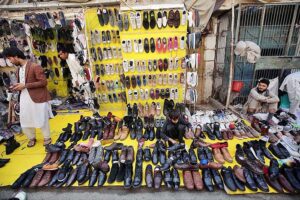 Vendor selling and displaying second hand shoes to attract the customers at Hashtnagri area