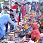 Peoples purchasing fireworks items from woman vendor in connection with Dewali festival