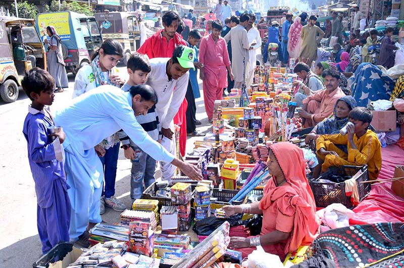 Peoples purchasing fireworks items from woman vendor in connection with Dewali festival