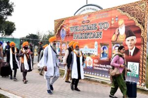 A large number of Sikh Yatrees stands in queue at Waghah Border for immigration procedure after arriving in Pakistan to participate in religious rituals on the occasion of 554th Birth Anniversary of Guru Nanak at Nankana Sahib