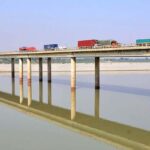 A view of heavy vehicles passing through the bridge on the Indus River at the bypass area
