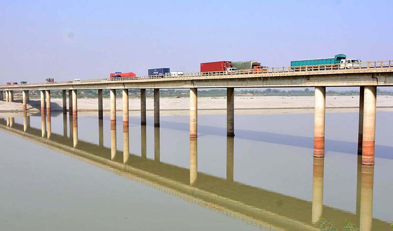 A view of heavy vehicles passing through the bridge on the Indus River at the bypass area