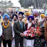 A large number of Sikh Yatrees stands in queue at Waghah Border for immigration procedure after arriving in Pakistan to participate in religious rituals on the occasion of 554th Birth Anniversary of Guru Nanak at Nankana Sahib