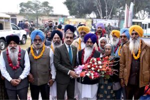 A large number of Sikh Yatrees stands in queue at Waghah Border for immigration procedure after arriving in Pakistan to participate in religious rituals on the occasion of 554th Birth Anniversary of Guru Nanak at Nankana Sahib
