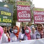 Doctors and paramedics hold placards during a pro-Palestinian rally organized by Pakistan Islamic Medical Association PIMA at Jinnah hospital