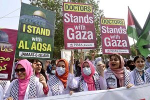 Doctors and paramedics hold placards during a pro-Palestinian rally organized by Pakistan Islamic Medical Association PIMA at Jinnah hospital