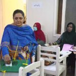 A female voter exercising her right to vote at a polling station in the metropolis during by-elections for direct Local Government (LG) seats