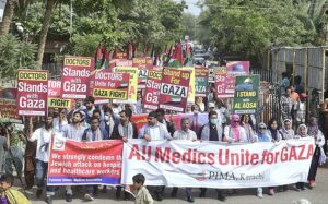 Doctors and paramedics hold placards during a pro-Palestinian rally organized by Pakistan Islamic Medical Association PIMA at Jinnah hospital